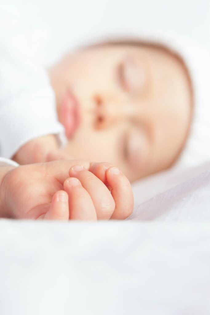 This image has an empty alt attribute; its file name is baby-lying-on-white-textile-3976431-683x1024.jpg