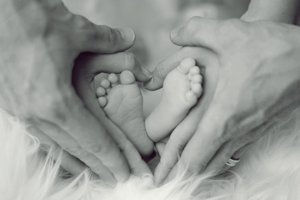 This image has an empty alt attribute; its file name is grayscale-photo-of-baby-feet-with-father-and-mother-hands-in-733881-1024x683.jpg
